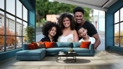 Happy African family hugging and embracing. Affectionate black family love Wall mural