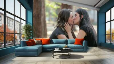 Lesbian couple kissing each other outdoors at the park LGBT women Wall mural