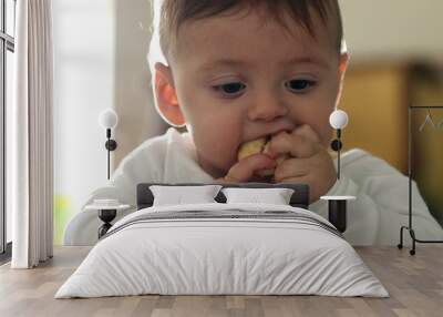 Messy baby infant eating applie fruit Wall mural