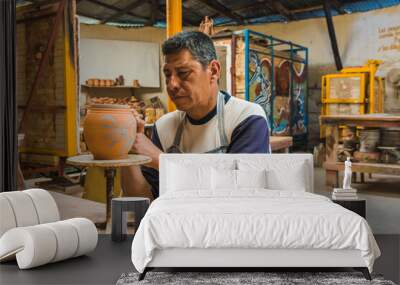 Mexican potter craftsman, working the clay with his hands in his workshop to create sculptures, vases, jugs, vases etc, using traditional methods. Wall mural