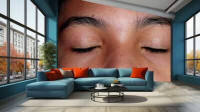 mixed race young boy closing eyes in meditation, child opening eyes smiling Wall mural