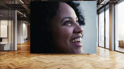 One young black woman closeup face looking at sky smiling with HOPE and FAITH. Grateful Brazilian person Wall mural