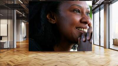 Optimistic black African woman feeling happy and satisfied, hopeful person Wall mural