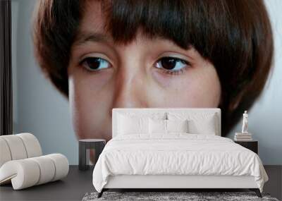 Portrait child boy thinking, close-up ethnically diverse kid looking for solution idea insight Wall mural