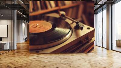 record player with a record on a table with records in the background Wall mural