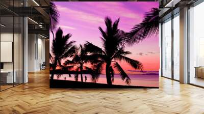 Palms silhouettes at sunset on a tropical beach Wall mural