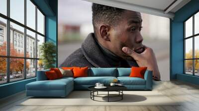 Stressed ou black African man feeling neck pain due to emotional struggle Wall mural