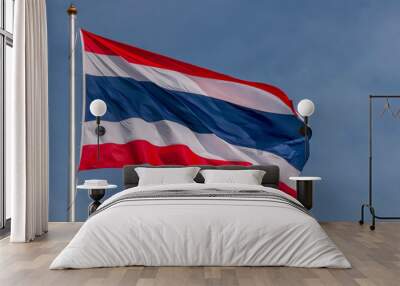 The national flag of Thailand flutters in the wind against a beautiful blue sky Wall mural