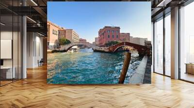 Typical view of the old city of Venice, Italy, with canals, bridges, ancient buildings immersed in water, boats and gondolas Wall mural