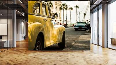 Vintage yellow car parked on a Cuban street. Havana classic taxi. Old times mood.  Wall mural