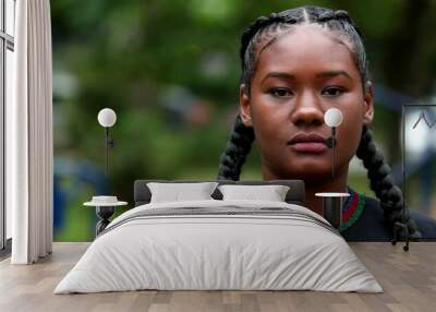 Young black African woman face, tracking shot of mixed race ethnicity girl standing outside at park Wall mural