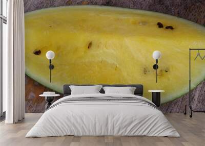 A slice of delicious, juicy sweet, fresh, yellow watermelon on a wooden table. Wall mural