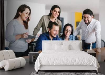 Group of latin business people working together as a teamwork while sitting at the office desk in a creative office in Mexico city Wall mural