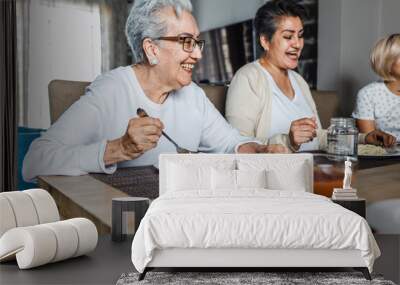 hispanic elderly woman eating dinner with family at home in Mexico Latin America Wall mural