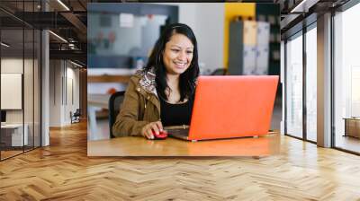 latin business woman working with computer at the office in Mexico city Wall mural