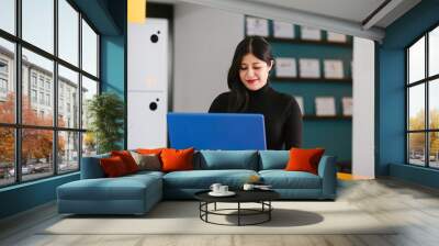 latin business woman working with computer at the office in Mexico city Wall mural