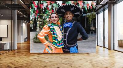 Latin couple of dancers wearing traditional Mexican dress from Guadalajara Jalisco Mexico Latin America, young hispanic woman and man in independence day or cinco de mayo parade or cultural Festival Wall mural