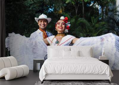 Latin couple of dancers wearing traditional Mexican dress from Veracruz Mexico Latin America, young hispanic woman and man in independence day or cinco de mayo parade or cultural Festival Wall mural