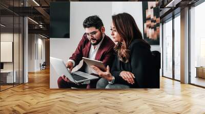 Latin couple using laptop at office in Mexico or Latin America people Business concept  Wall mural