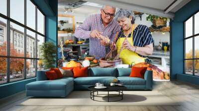 Latin senior couple cooking a turkey meat together for Christmas dinner at home in Mexico Latin America, hispanic people preparing food in thanksgiving holidays	 Wall mural