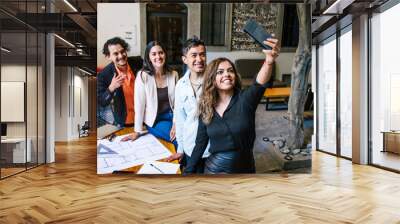 latin woman and team taking a photo selfie in a creative office Wall mural