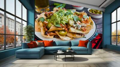 Mexican Nachos with cheese or tortilla chips with meat, avocado and beer, tex mex food in Mexico America Wall mural