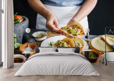 Mexican woman hands preparing tacos al pastor and eating mexican food in Mexico Latin America Wall mural