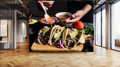 Mexican woman hands preparing tacos with sauce traditional food in Mexico Latin America Wall mural