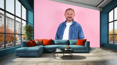 portrait of hispanic senior man wearing casual clothes smiling at camera on pink background in Mexico Latin America Wall mural