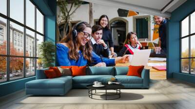 Smiling young latin business people having online business meeting at workplace in Mexico Wall mural