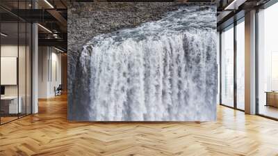 Two men standing near Dettifoss waterfall in Iceland. Wall mural