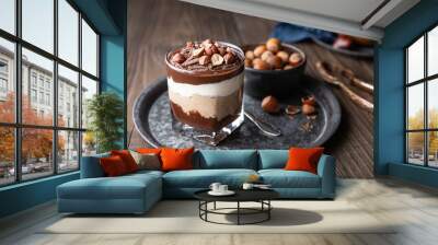 Layered dessert with chocolate mousse, cream cheese and whipped cream mixed with chestnut puree, topped with hazelnuts in a glass jar Wall mural