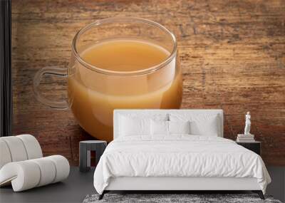 glass cup of beef bone broth on a grunge wood table Wall mural