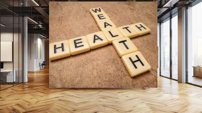 health and wealth crossword in ivory letter tiles against textured handmade paper, wellbeing concept Wall mural