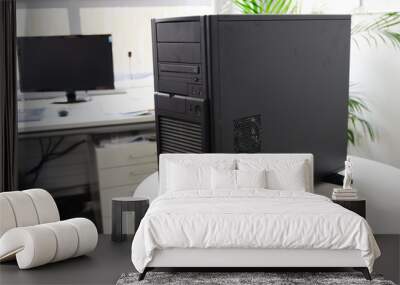 black server computer in a tower case on a white table in the office, selected focus Wall mural