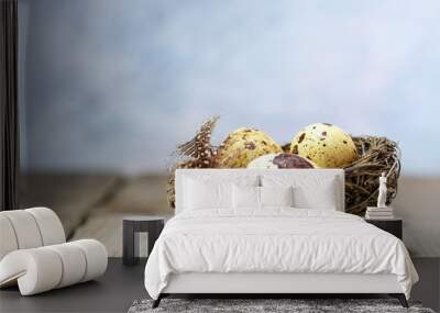 nest with tree eggs on a rustic vintage table, bright blue backg Wall mural