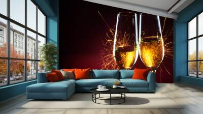 New Year party time with two champagne glasses and sparklers against a dark red background Wall mural