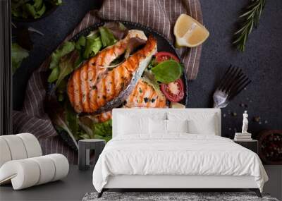 Cooked salmon fish with vegetables on dark background Wall mural