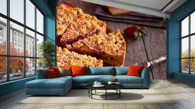 Delicious crumble cake with strawberry on wooden background Wall mural