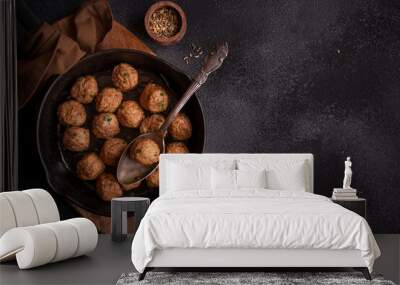 Meatballs in a frying pan on dark background Wall mural