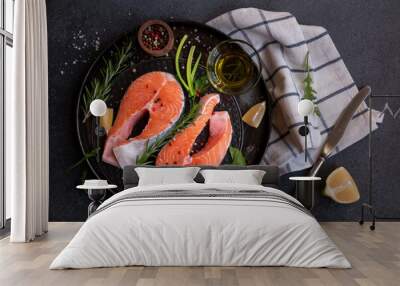 Uncooked raw salmon fish with herbs on dark background Wall mural