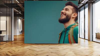 A happy young white man with a backpack enjoying travel and adventure Wall mural