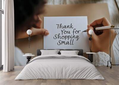 African american women writting a thank-you card for shopping small, promoting local businesses and customer appreciation, ideal for Small Business Saturday and Giving Tuesday Wall mural