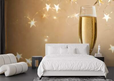 A glass of champagne with golden stars on the light background. Happy new year celebration. AI generated. Wall mural