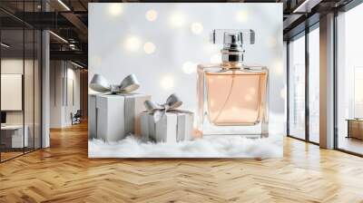 A beautiful perfume bottle is placed next to a gift box in fresh snow, present for New Years Eve, Christmas and winter holidays. Wall mural