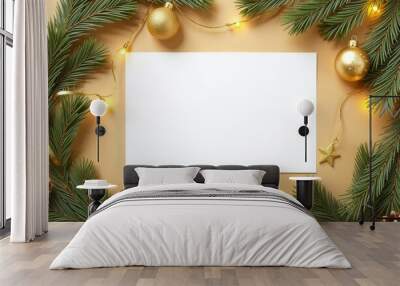 A white card is surrounded by Christmas decorations on golden background Wall mural