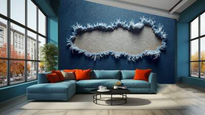 Torn textured blue fabric with frayed edges revealing light background, with copy space for design,  ripped fabric texture, denim jeans texture Wall mural