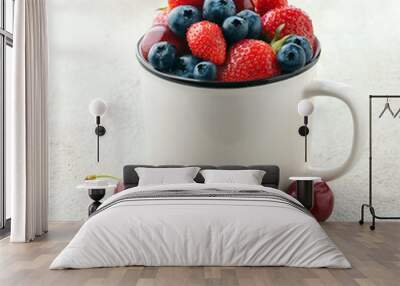 Sweet strawberies and blueberries in mug Wall mural