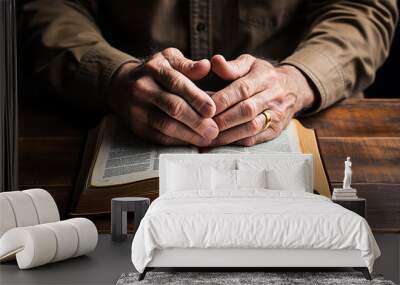 wrinkled The hands of an elderly man are folded over the Bible. Wall mural