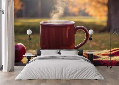 Red mug with hot apple cider and apple in cozy autumn setting Wall mural